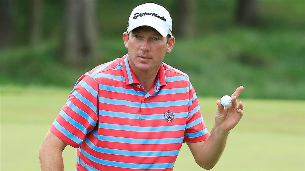 Jim Herman raises his Pro V1 golf ball after holing a birdie putt at the 2019 Barbasol Championship